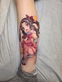 a tattoo of a girl with a bow on her leg