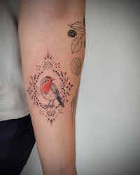 a tattoo of a bird on a forearm