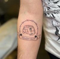 a tattoo of a guinea pig with the words tough guy